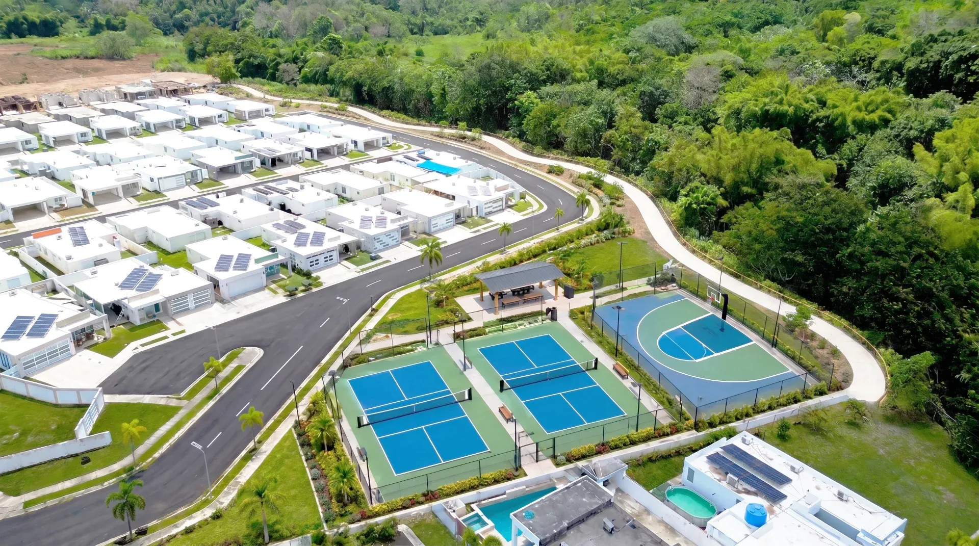 Aerial view of Masías at the Hills with sports courts and homes