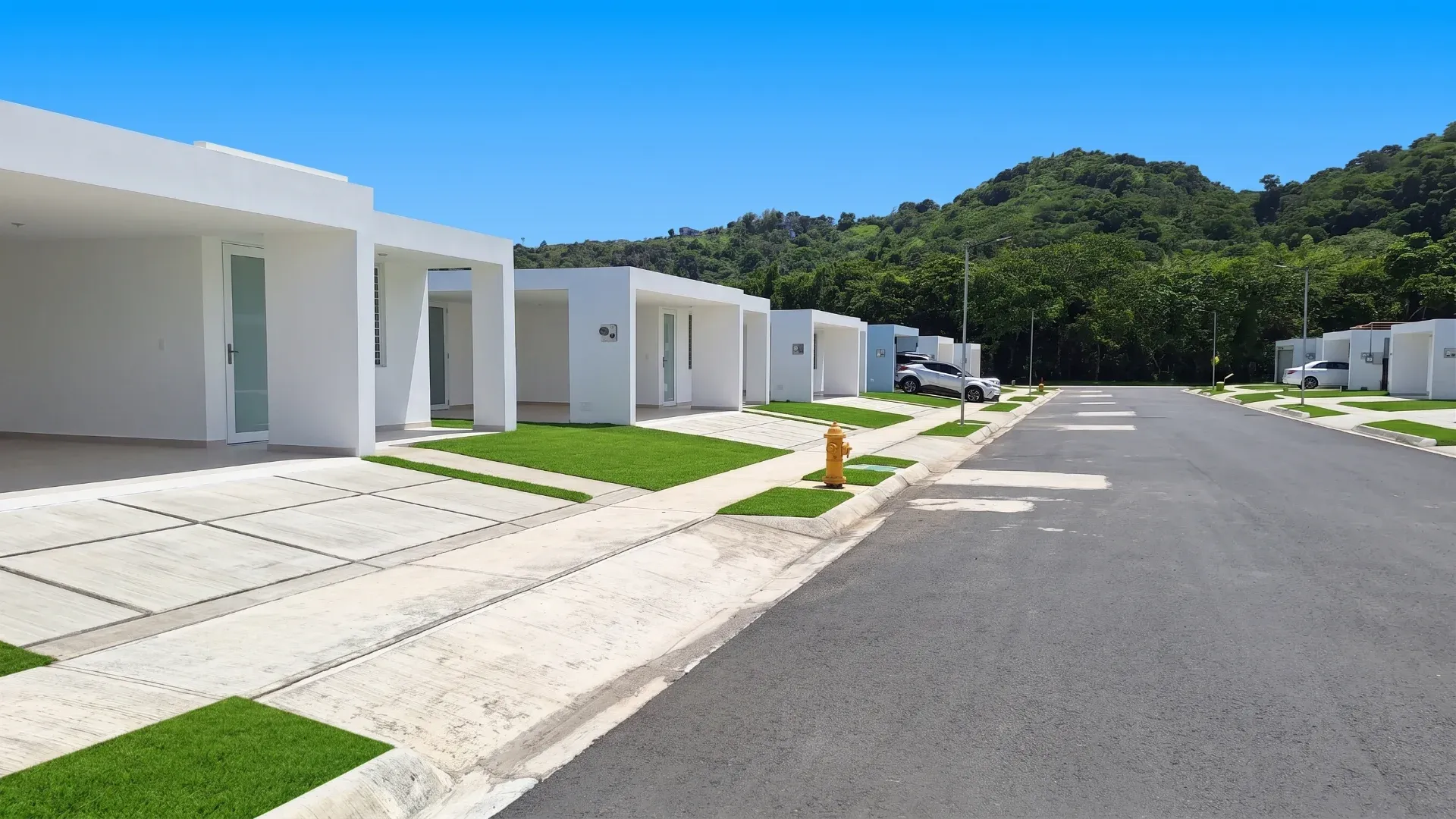 Residential street at Masías at the Hills with white homes